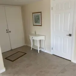 Entryway with white console table, framed artwork, and door at Sunrise Serenity: Panoramic Views & Resort Living - by Open Air Homes