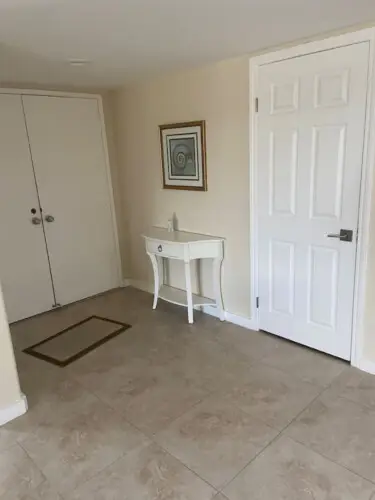 Entryway with white console table, framed artwork, and door at Sunrise Serenity: Panoramic Views & Resort Living - by Open Air Homes