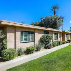 Exterior of house with lawn and shrubs at Sunrise Serenity: Panoramic Views & Resort Living - by Open Air Homes