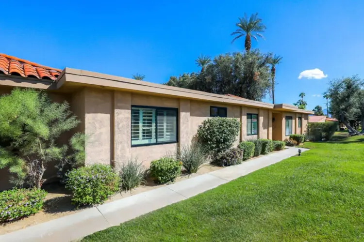 Exterior of house with lawn and shrubs at Sunrise Serenity: Panoramic Views & Resort Living - by Open Air Homes