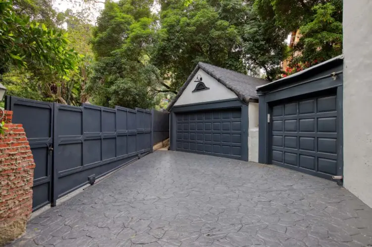 Driveway leading to garage at Laurel Canyon Classic Hollywood Residence with Pool by Open Air Homes.