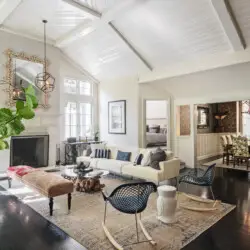 Well-lit living room in Laurel Canyon Classic Hollywood Residence W/ Pool featuring a vaulted ceiling, large sofa, armchairs, coffee table, and decorative elements by Open Air Homes.