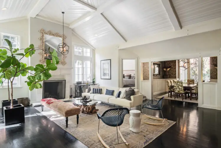 Well-lit living room in Laurel Canyon Classic Hollywood Residence W/ Pool featuring a vaulted ceiling, large sofa, armchairs, coffee table, and decorative elements by Open Air Homes.