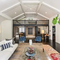 Spacious living room in Laurel Canyon Classic Hollywood Residence W/ Pool featuring a vaulted ceiling, large sofa, armchairs, coffee table, and decorative elements by Open Air Homes.