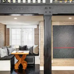 Cozy seating area in Laurel Canyon Classic Hollywood Residence W/ Pool featuring a built-in bench, cushions, and a small table by Open Air Homes.