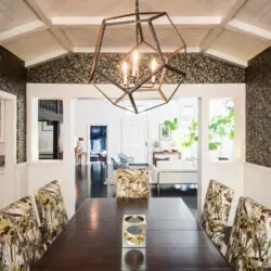 Dining room with chandelier and floral-patterned chairs at Laurel Canyon Classic Hollywood Residence W/ Pool by Open Air Homes.