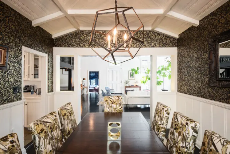 Dining room with chandelier and floral-patterned chairs at Laurel Canyon Classic Hollywood Residence W/ Pool by Open Air Homes.