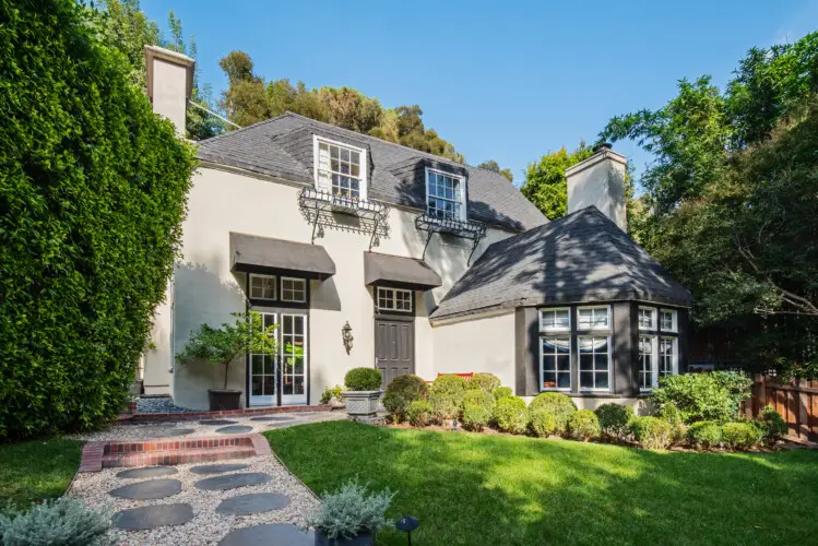 Exterior of Laurel Canyon Classic Hollywood Residence W/ Pool featuring a well-maintained lawn, paved walkway, and classic facade by Open Air Homes.