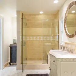 Bathroom interior of Laurel Canyon Classic Hollywood Residence W/ Pool featuring a glass-enclosed shower, vanity with round mirror, and elegant fixtures by Open Air Homes.