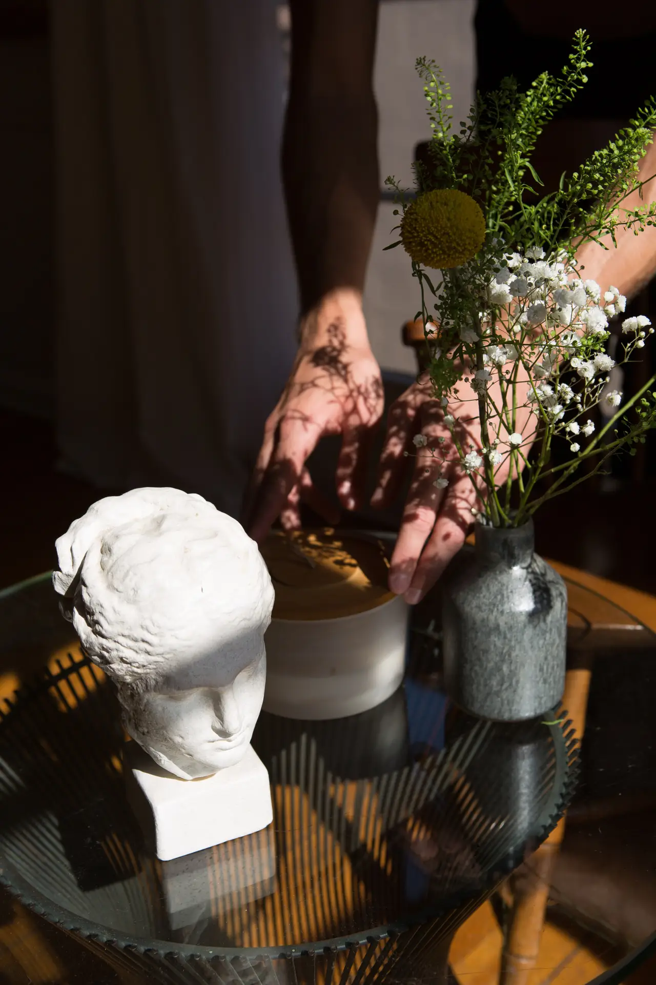 Table with a vase of flowers and a small sculpture at Open Air Homes' luxury vacation rental.