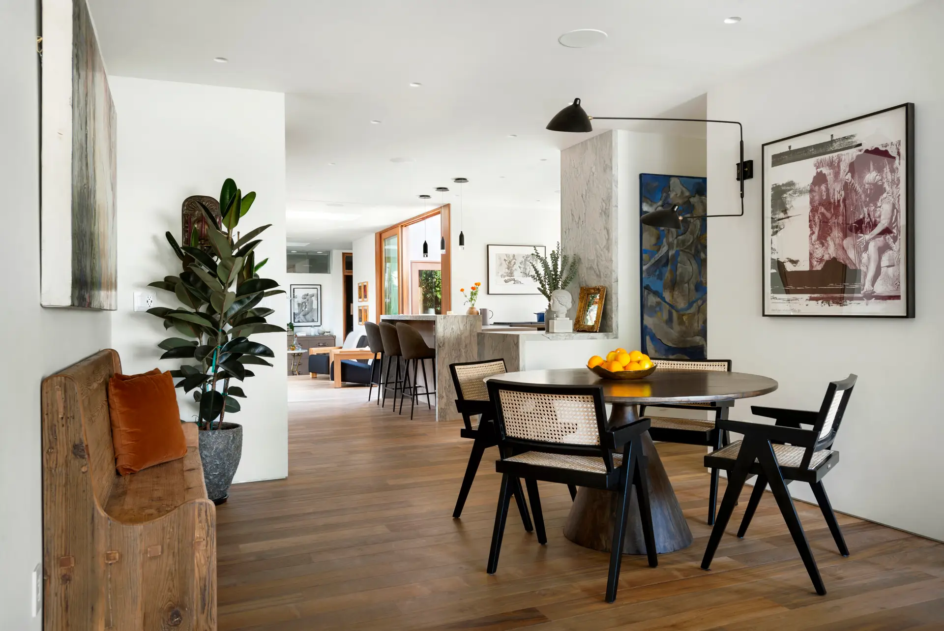 Westwood Airbnb Management - Modern dining area with wooden table, chairs, bench, and wall art - Open Air Homes