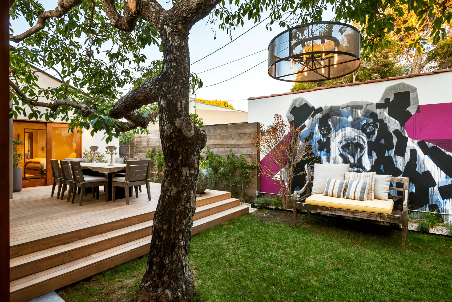 Westwood Airbnb Management - Beautifully landscaped backyard with seating area, fire pit, and tree providing shade - Open Air Homes