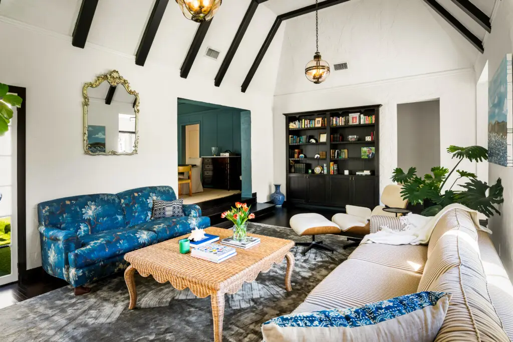 Living room with blue sofa, coffee table, and bookshelf in a Beverly Grove rental.
