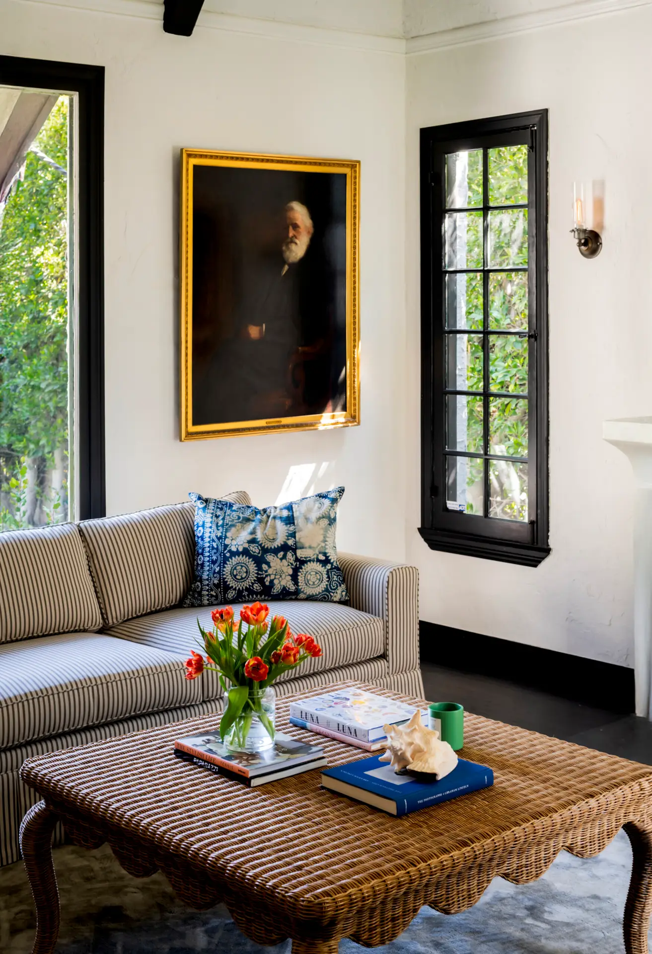Beverly Grove Airbnb Management - Living room corner with sofa, coffee table, and painting in a Beverly Grove rental.