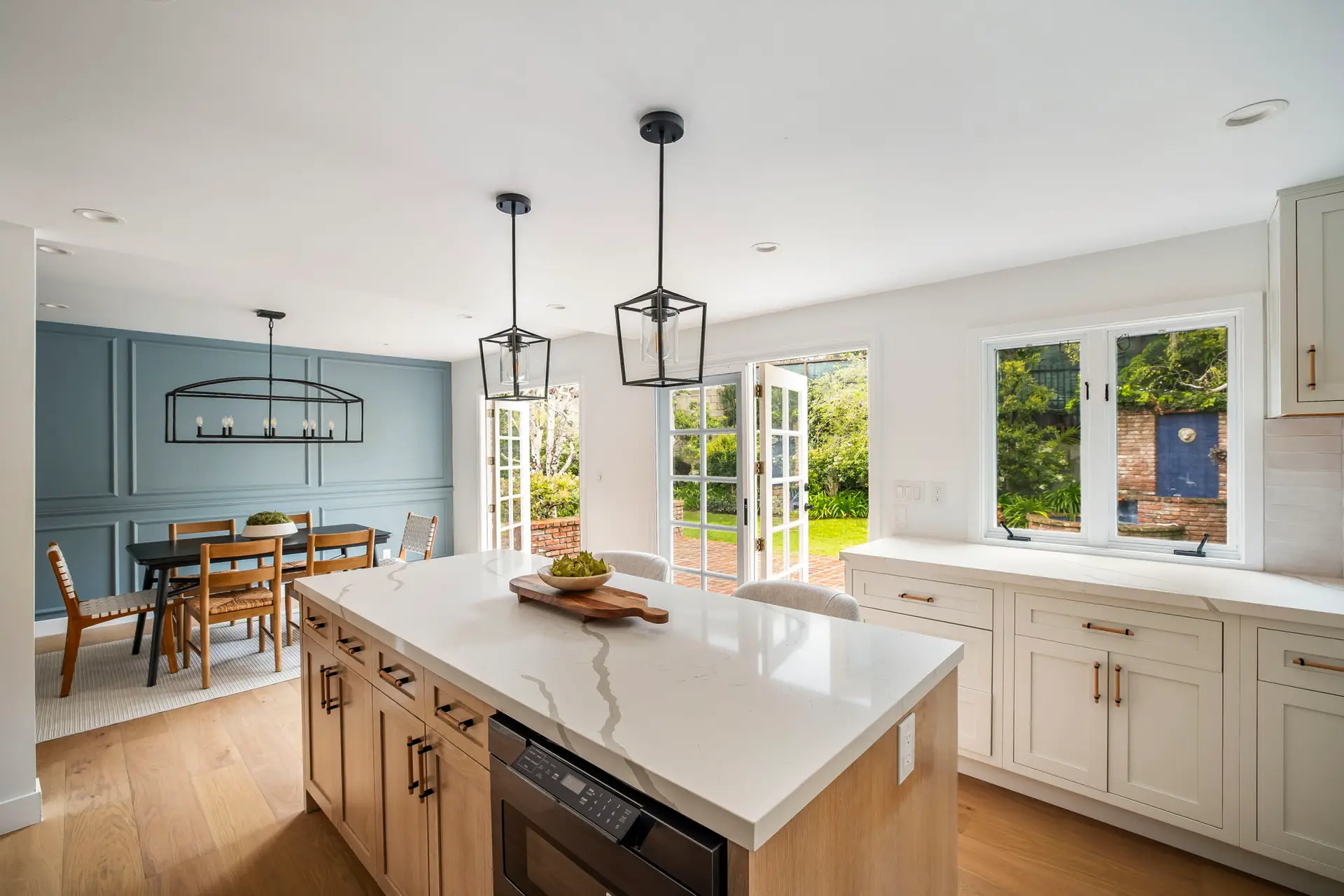 Playa Vista Airbnb Management - Kitchen with island and dining area in Pacific Palisades home.