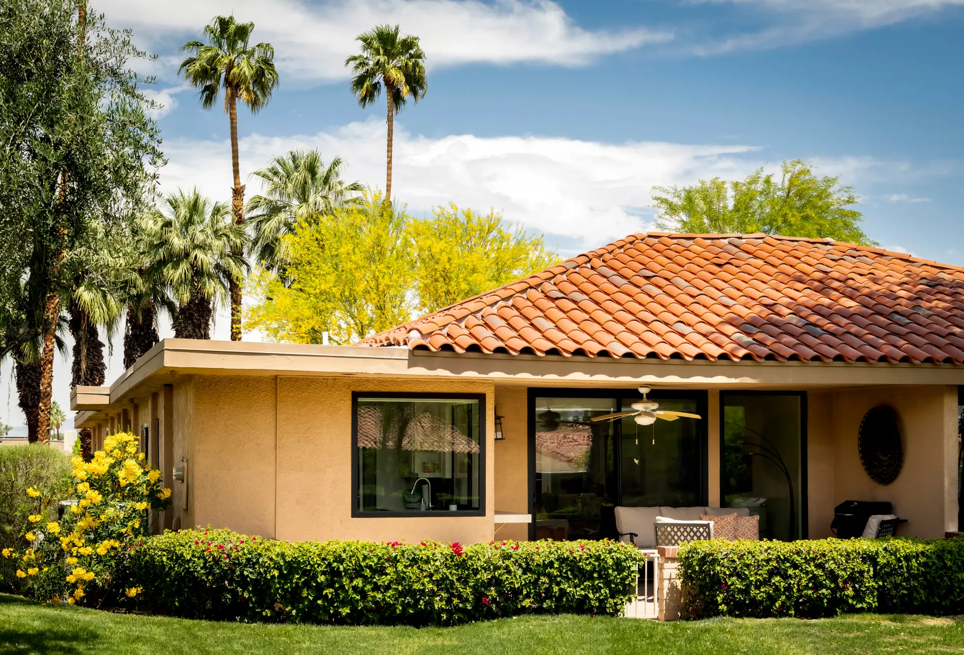 Sunrise Country Club house with red-tiled roof and palm trees in Rancho Mirage.