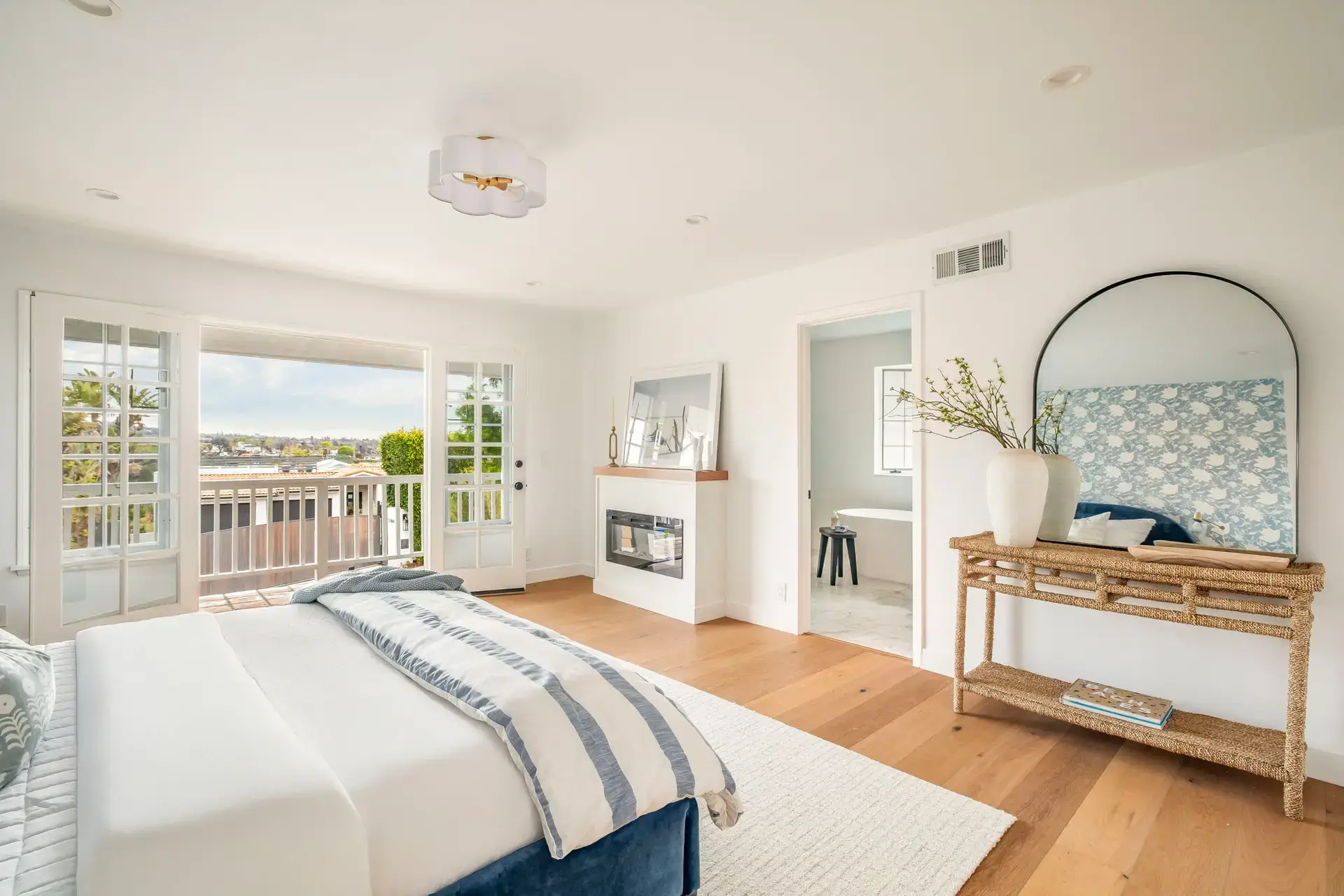 Rancho Palos Verdes Airbnb Management - Bedroom with fireplace and balcony view