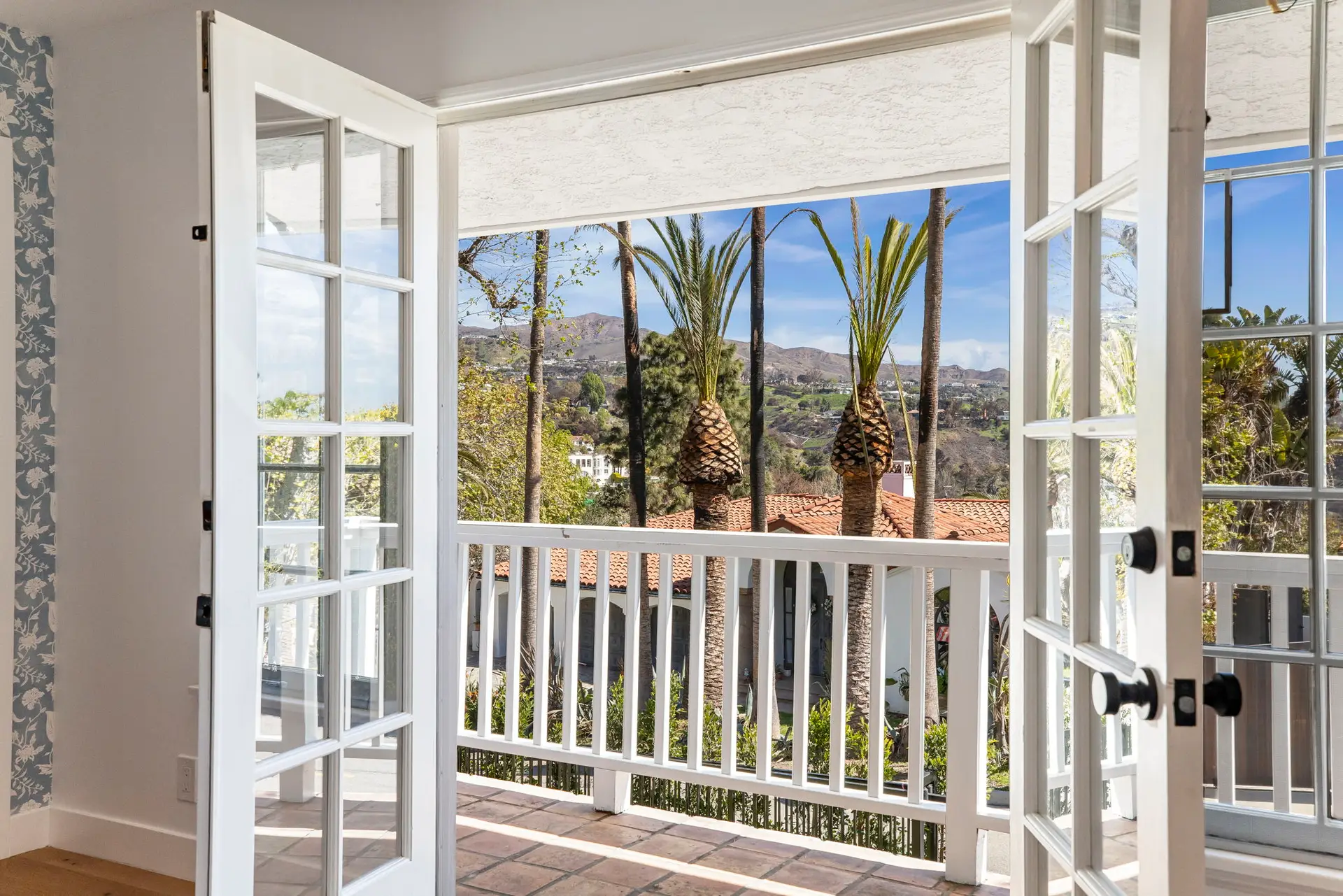 Rancho Palos Verdes Airbnb Management - Bedroom with fireplace and balcony view