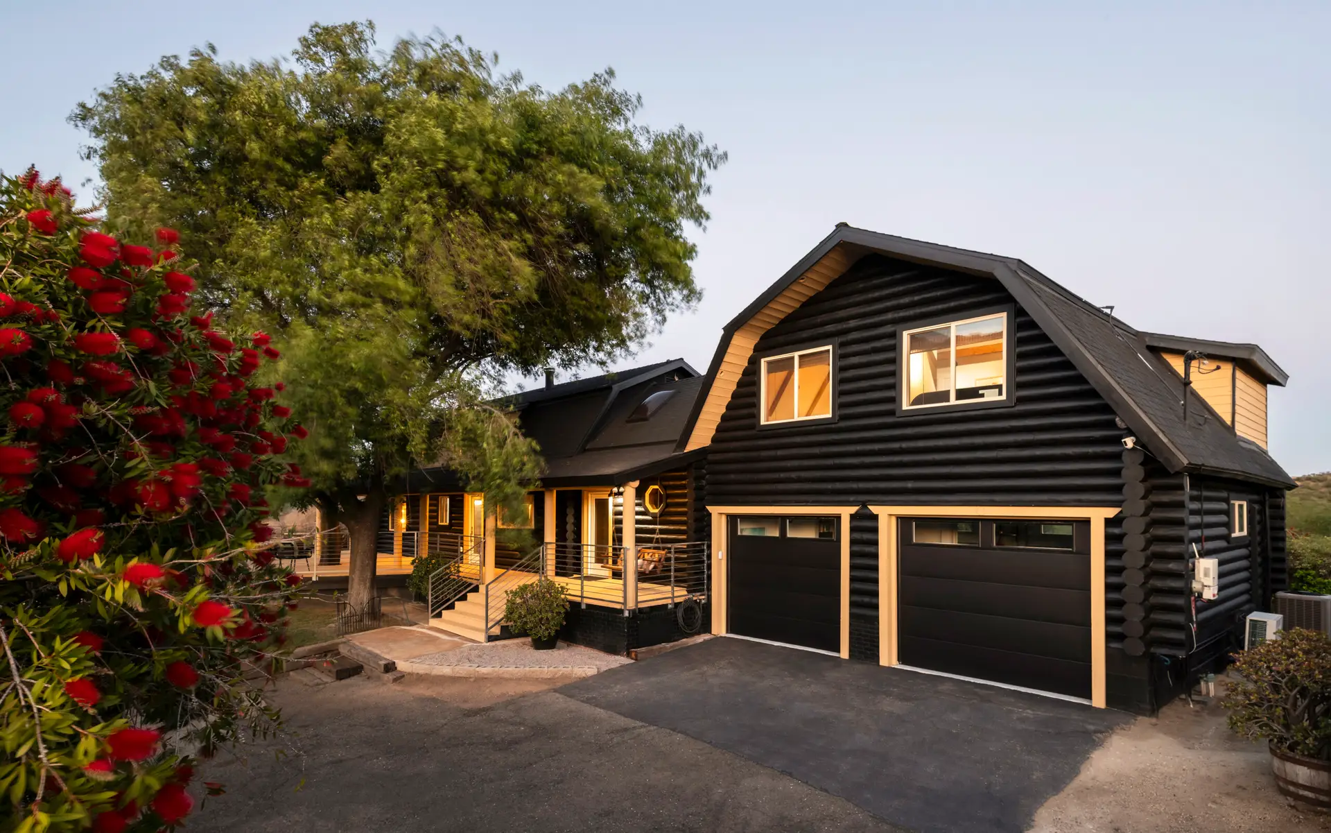Encino Airbnb Management - Exterior of log cabin with driveway and garage at Retreat to the Rocks, Ventura County