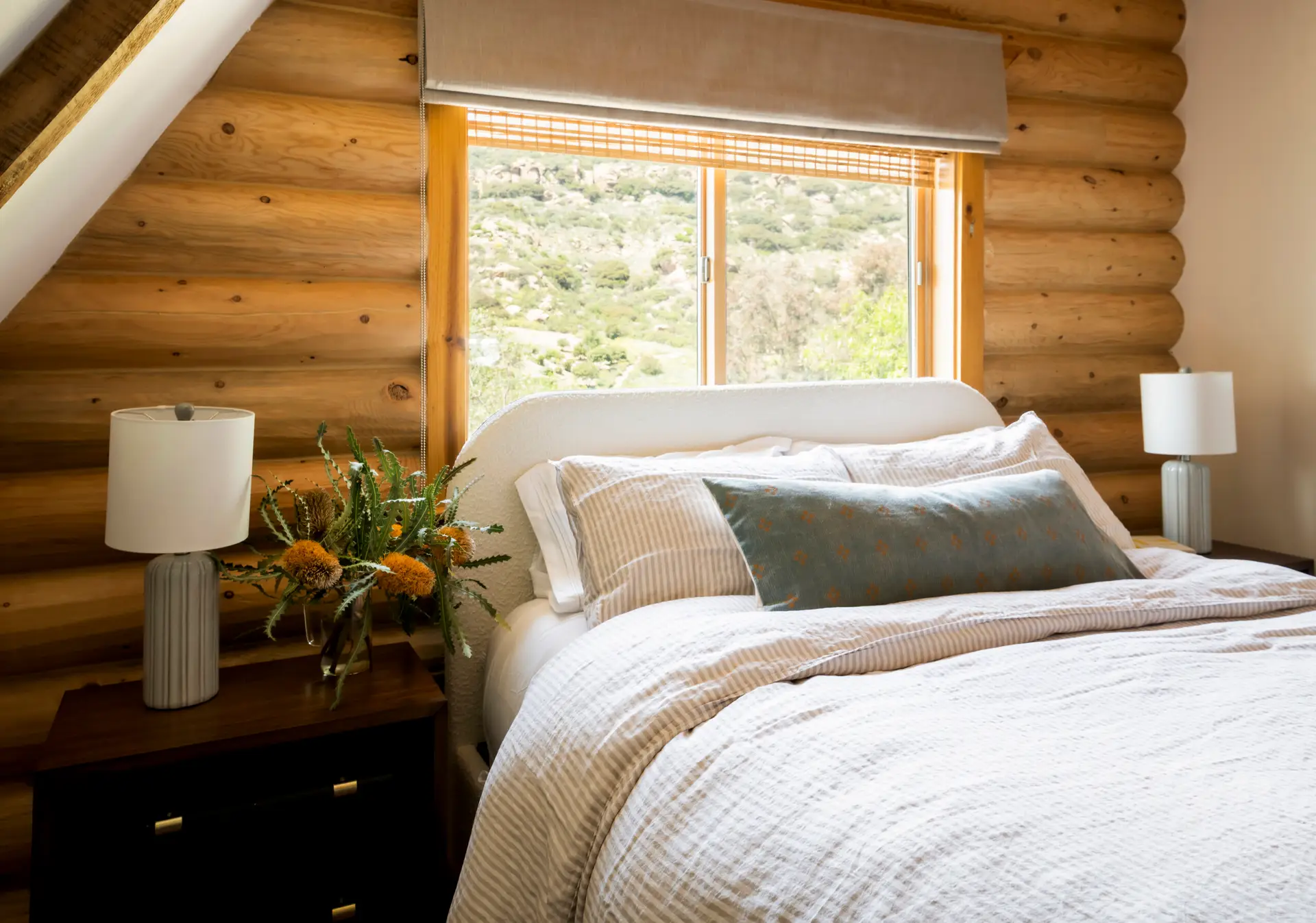Bedroom with wooden walls and window view at Retreat to the Rocks, Ventura County