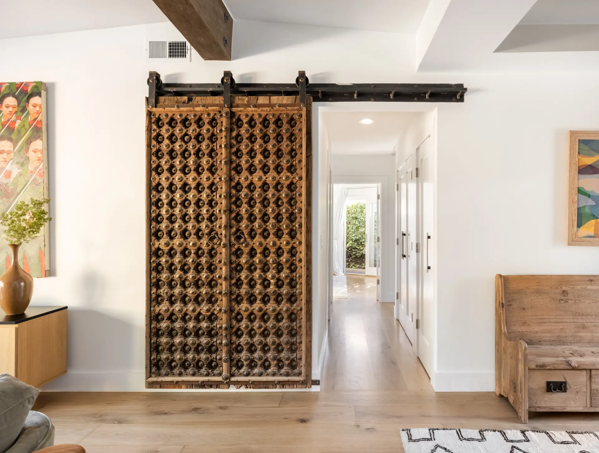 Eagle Rock Airbnb Management - Hallway with large intricately designed wooden door at Pacific Ave short-term rental, Venice Beach.