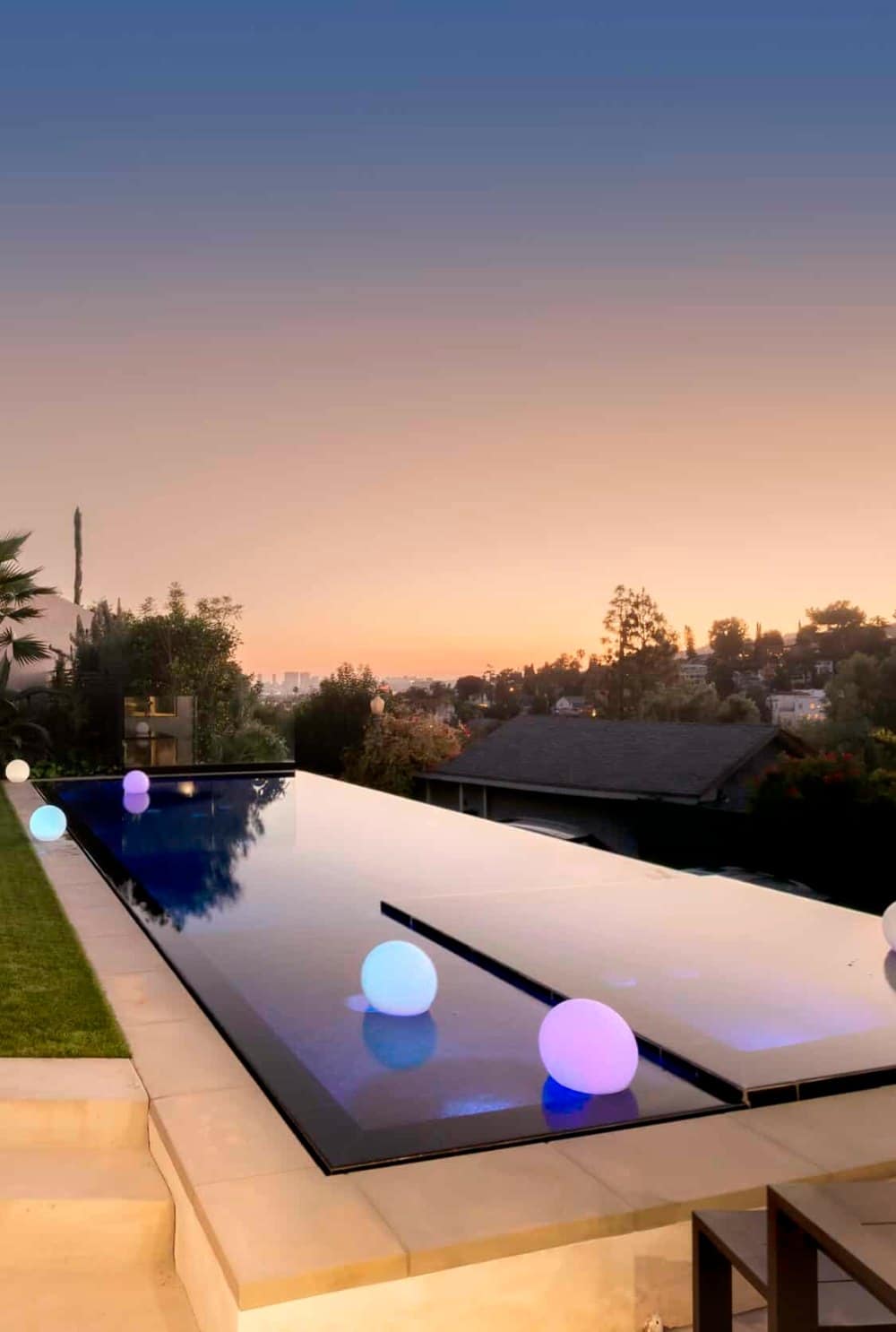 Infinity pool at dusk with city lights at a Hollywood Hills home managed by Open Air Homes, the best Airbnb property management company in Los Angeles by AirDNA ranking