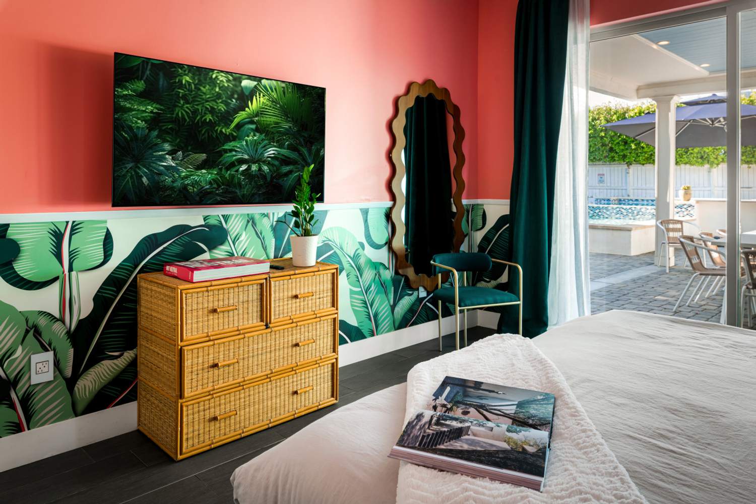 Bedroom with a coral accent wall and palm print headboard