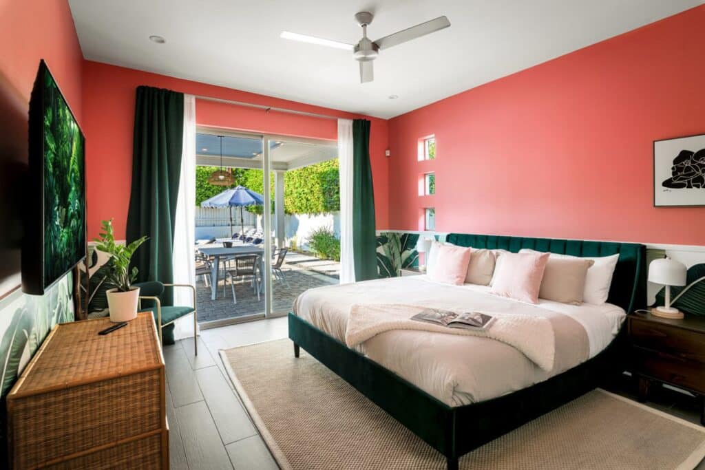 Bedroom with sliding doors opening onto the pool deck