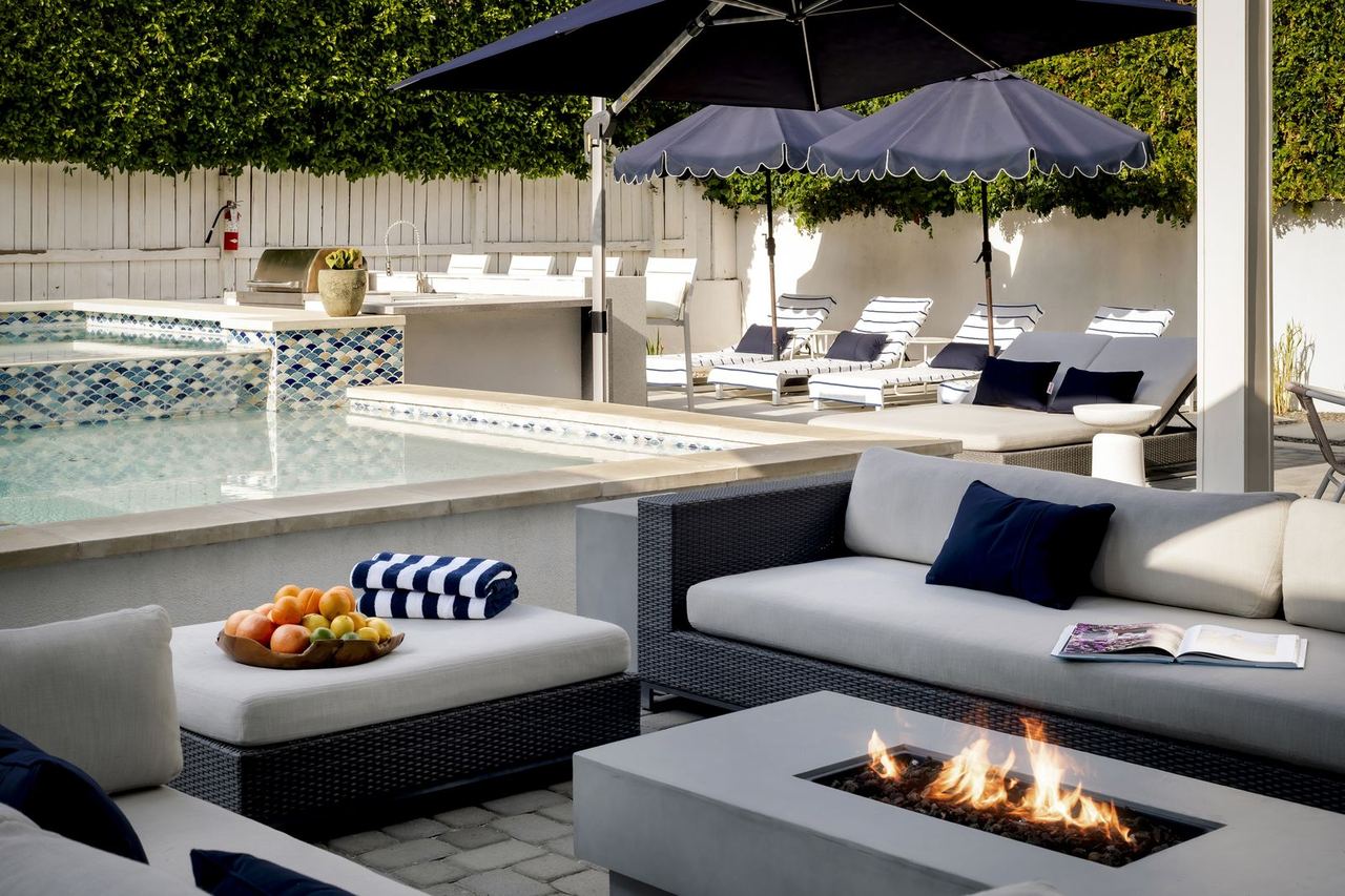 Vacation rental renovation ROI: new poolside lounge seating and fire table in Palm Springs