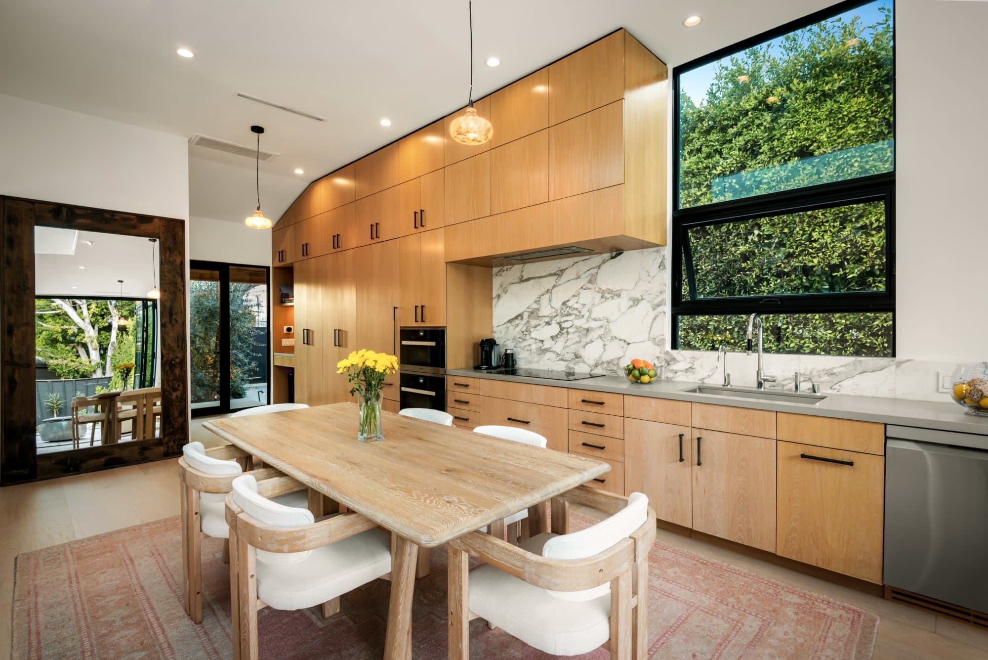 Kitchen and dining table with natural light and pocket doors
