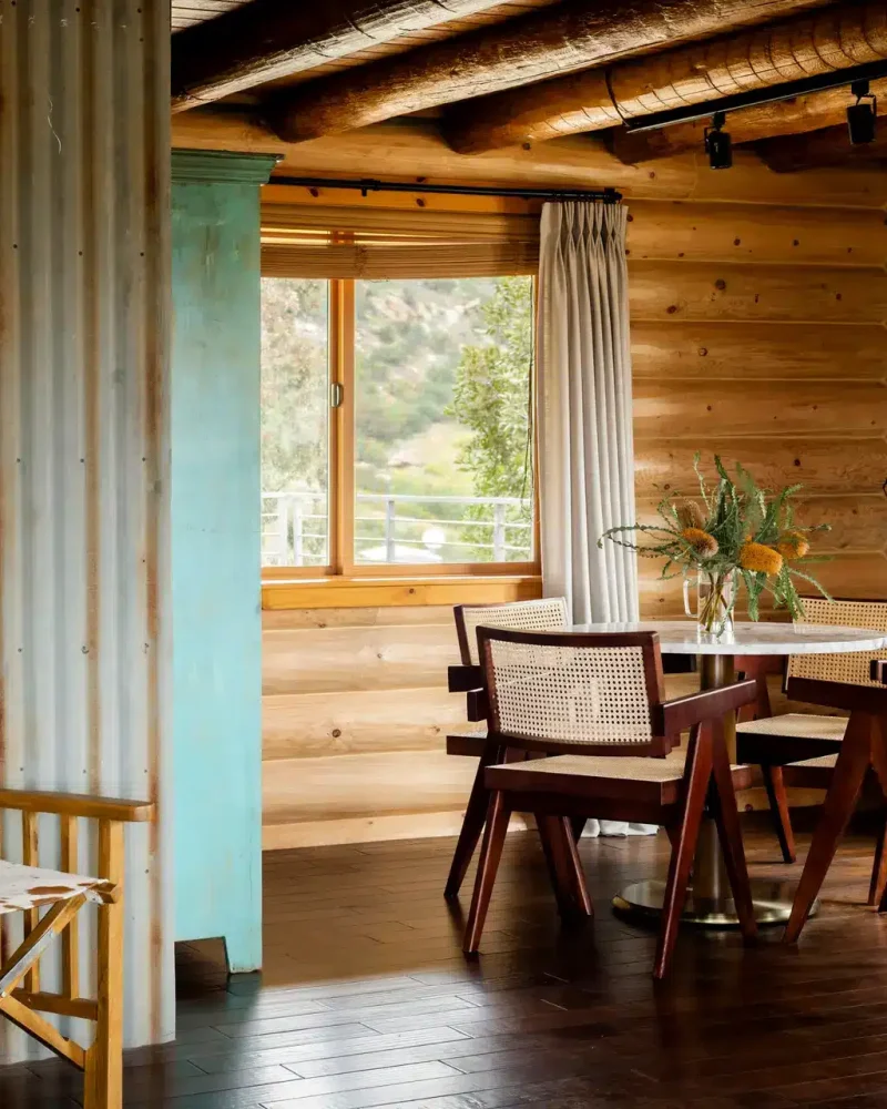 Rustic dining area with wooden table and chairs at Retreat to the Rocks, Ventura County