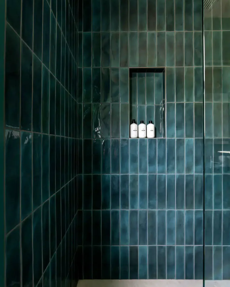 Luxury shower with green tiles and shelf in Venice Beach rental