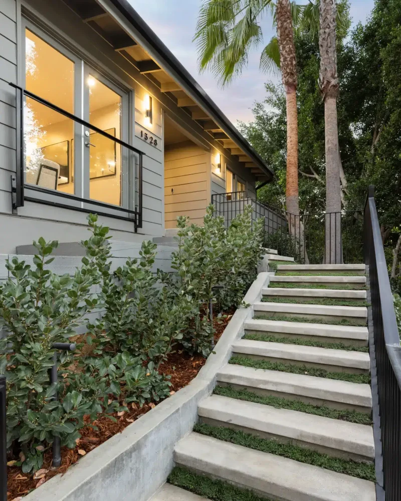 Exterior view of a home with staircase and garden - Open Air Homes