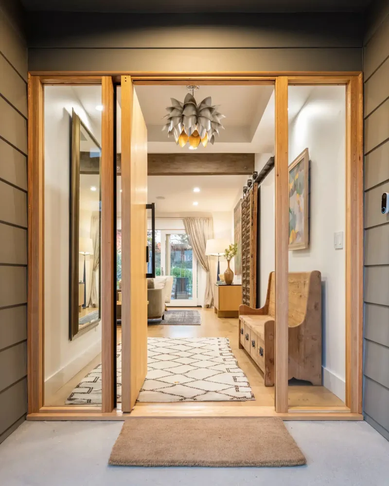 Entryway with large wooden doors leading into a well-lit interior at Pacific Ave short-term rental, Venice Beach.