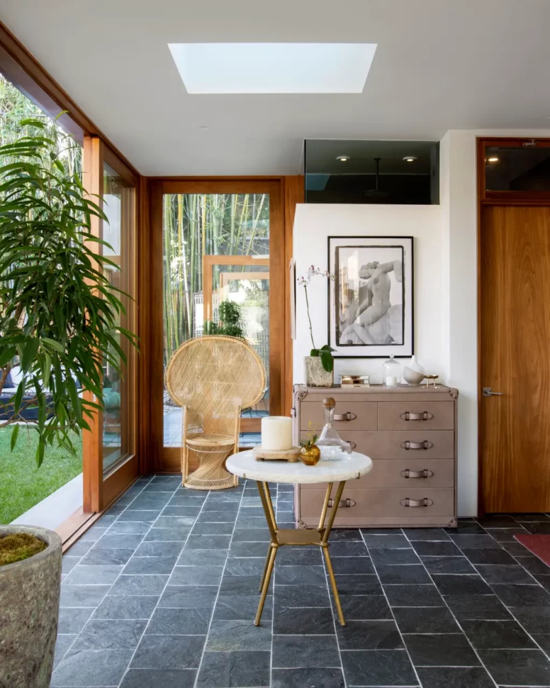 Open Air Homes - Hallway with tiled floor, plant, and seating area - Open Air Homeses provides flexible solutions for Los Angeles’ short-term rental market.