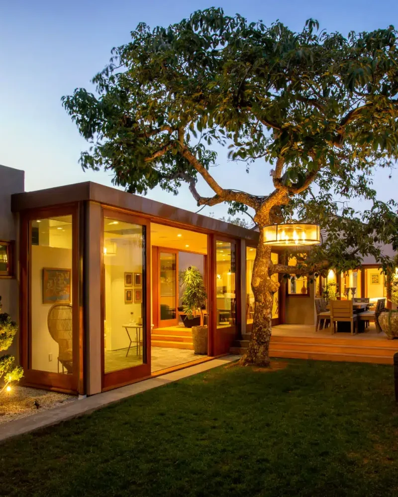 Cozy outdoor seating area with wooden steps leading to patio - Open Air Homes