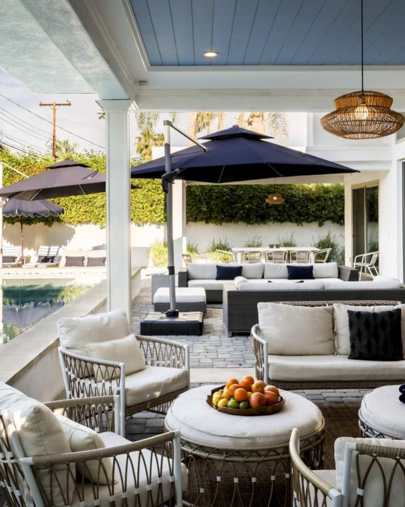 Covered patio with dining seating beside the pool