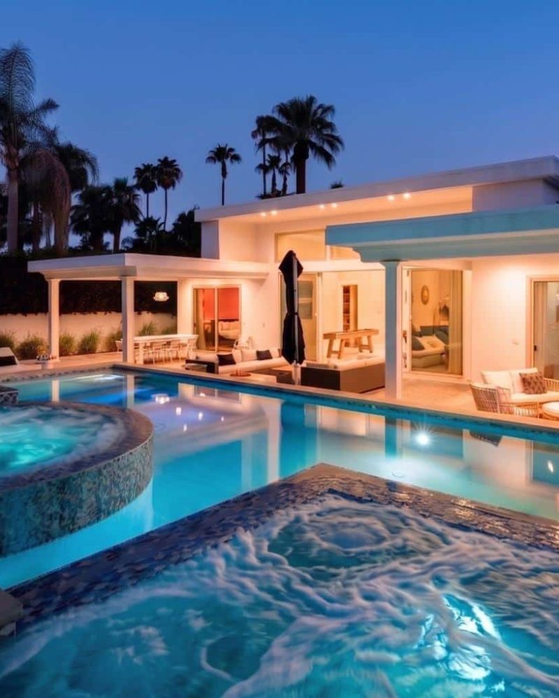 Palm Springs vacation rental with pool and spa lit at dusk at Ocotillo Retreat
